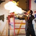 Man blowing fire in a warehouse