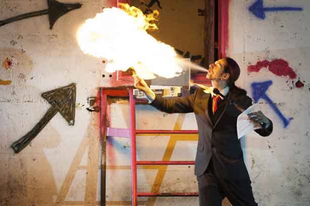Man blowing fire in a warehouse